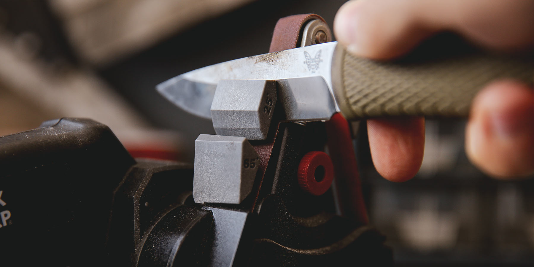 A Benchmade pocket knife is being sharpened at 25 degrees in the Work Sharp Knife and Tool Sharpener Outdoor Guide