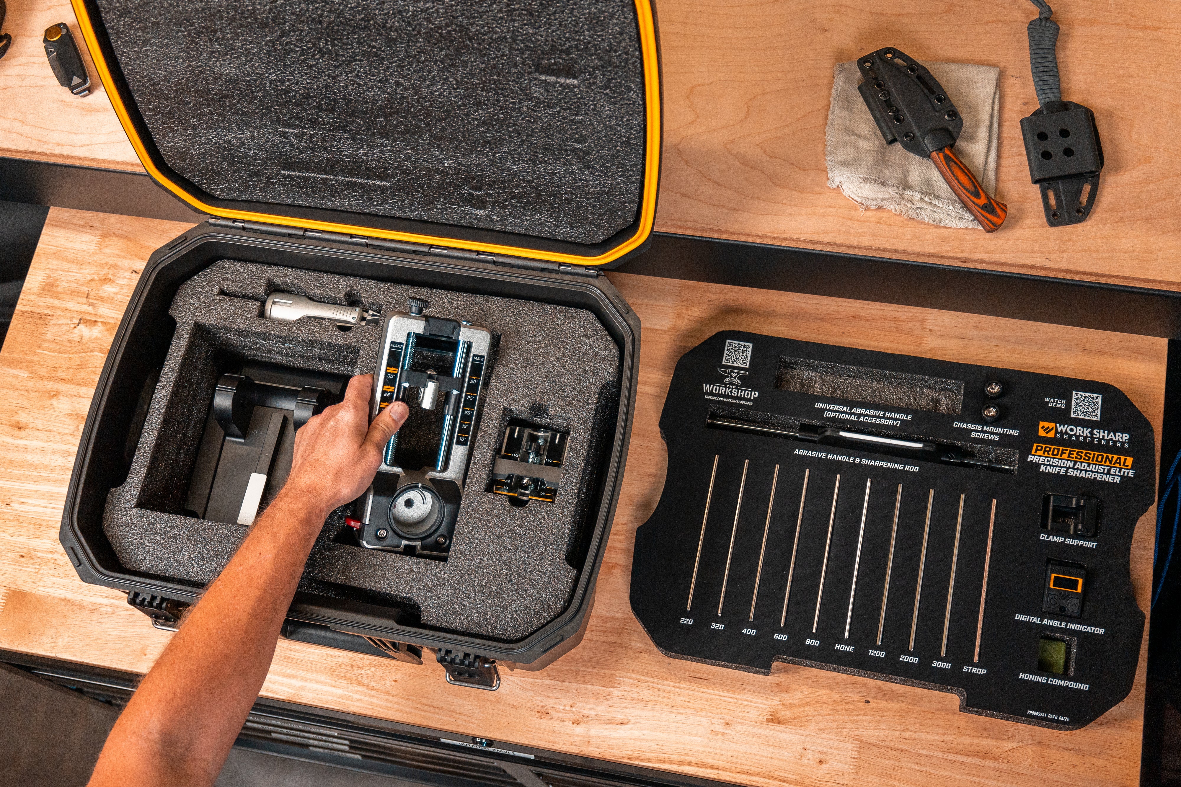 A hand removing the Professional Precision Adjust Elite from its custom carrying case.