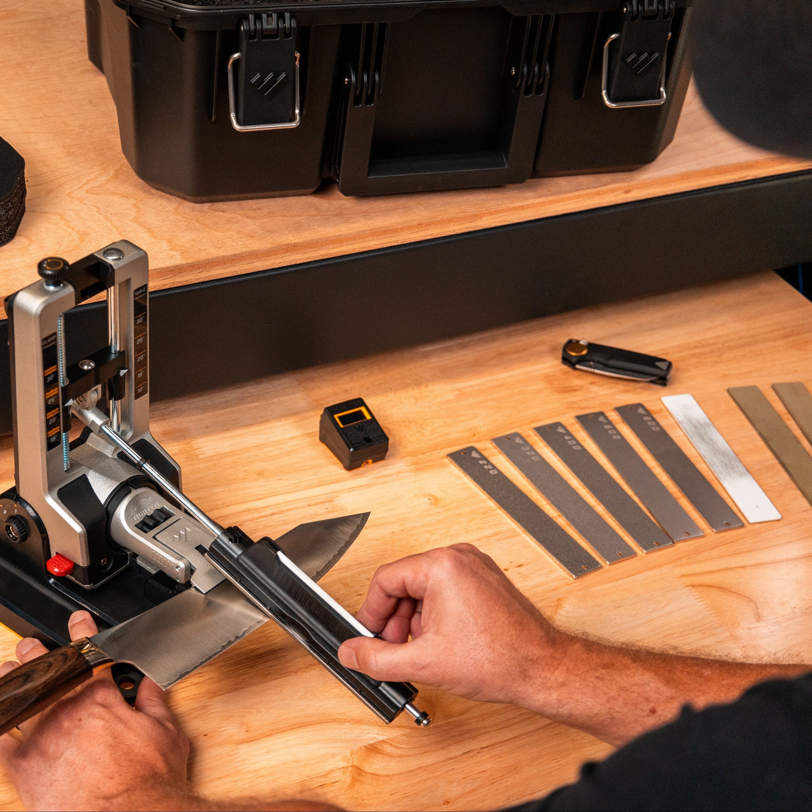 Professional Precision Adjust Elite knife sharpener in use on kitchen knife with abrasives.