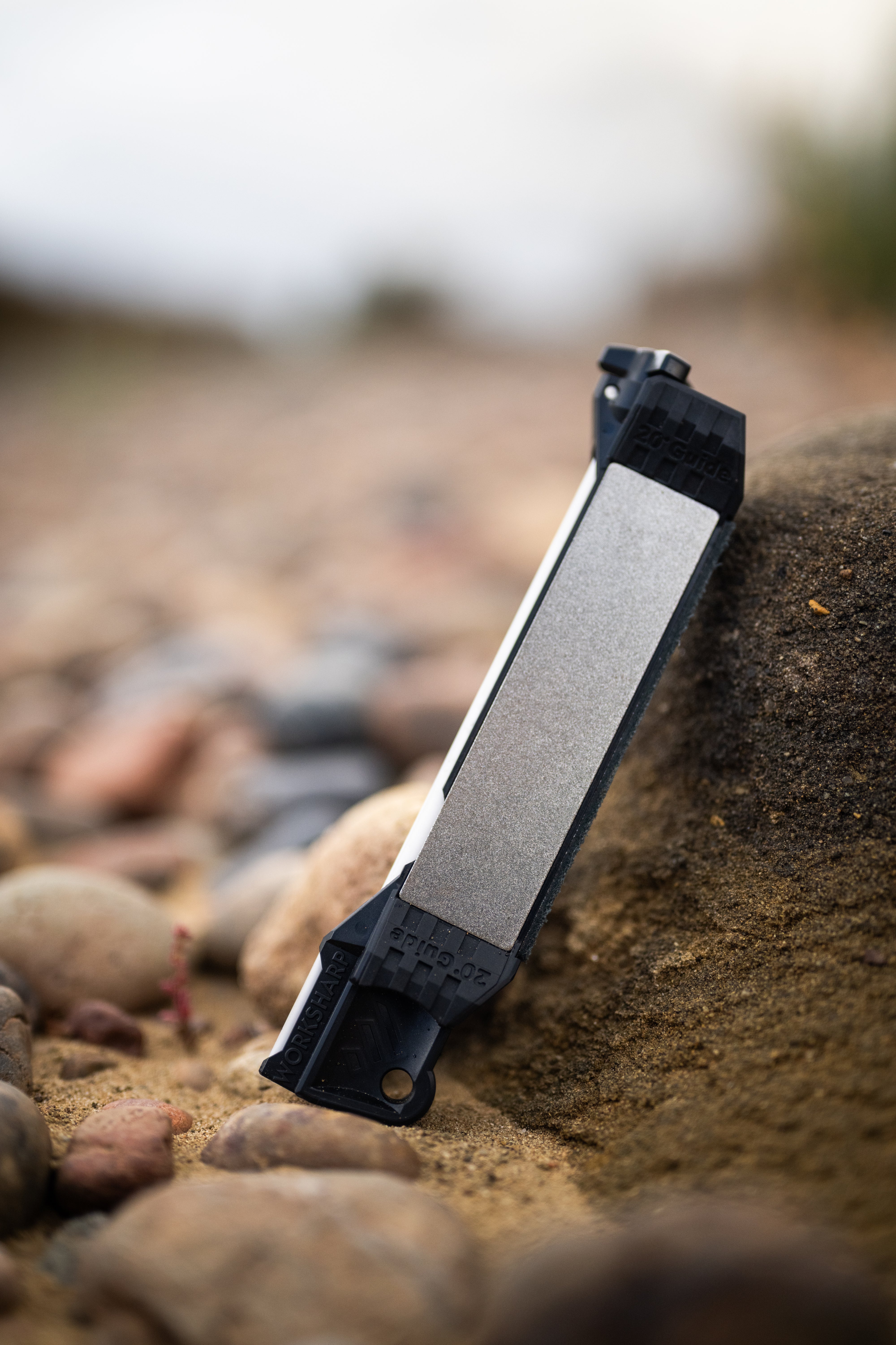 Guided Field Sharpener Blackout | Reserve Series on a rocky surface with a blurred natural background