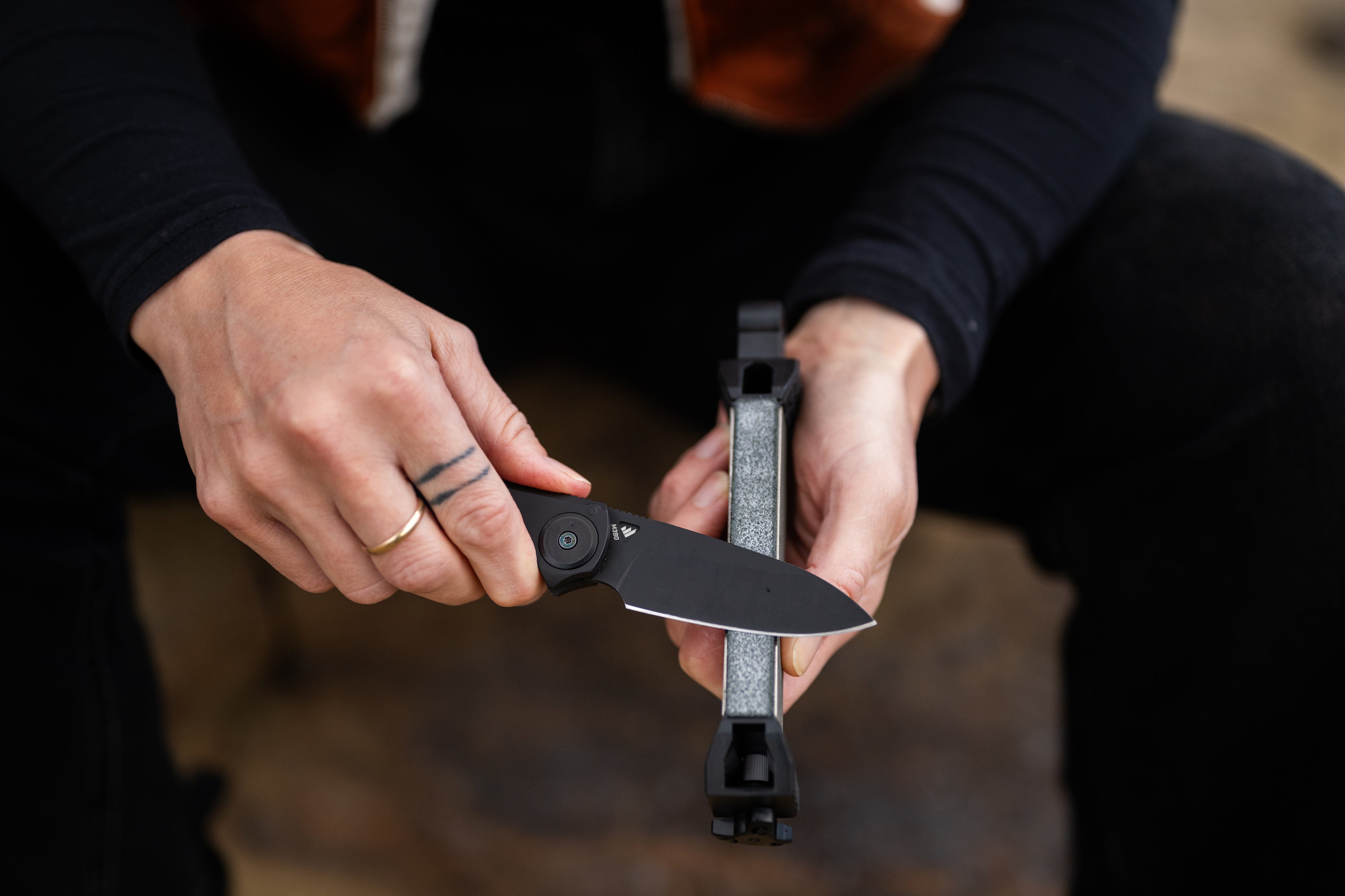 Person holding a fGuided Field Sharpener Blackout | Reserve Series with a blurred background