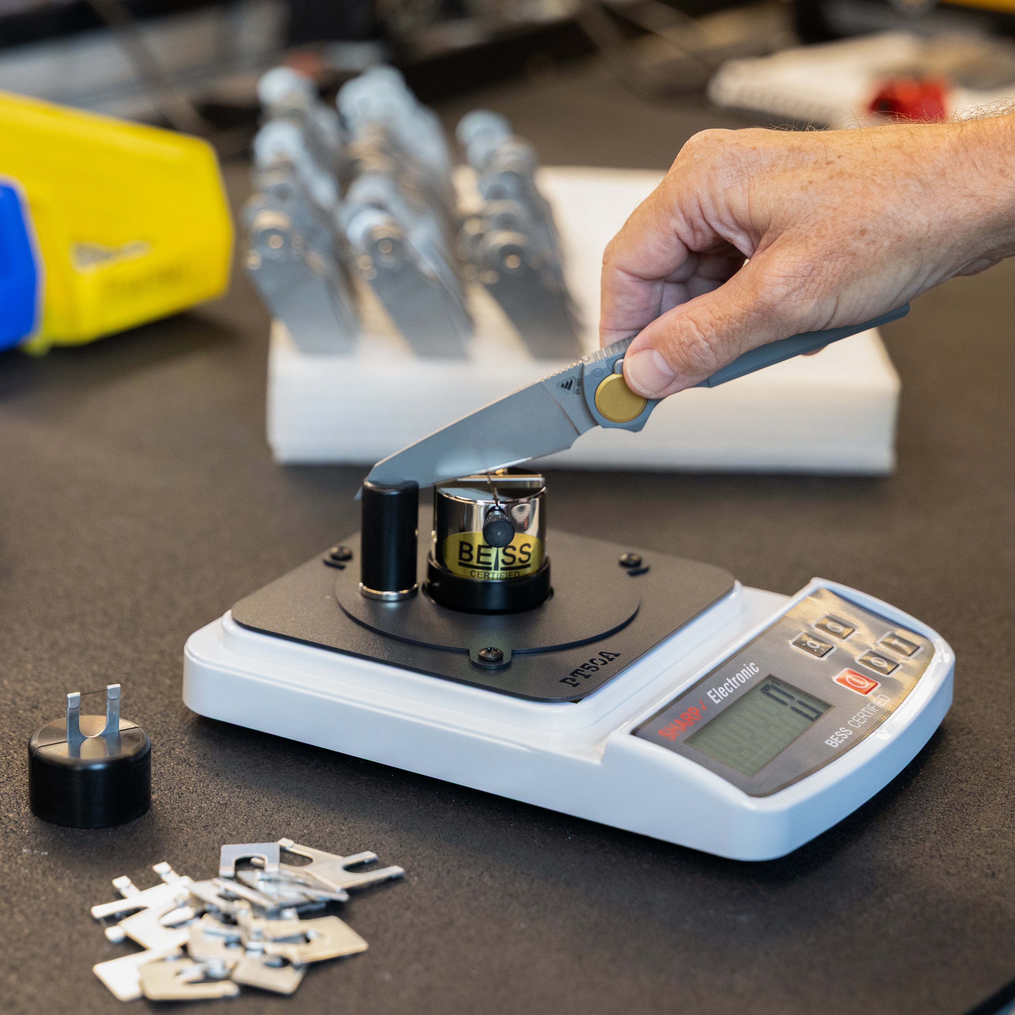 Action shot of Edge On Up Industrial sharpness tester in use on Work Sharp RMX knife.